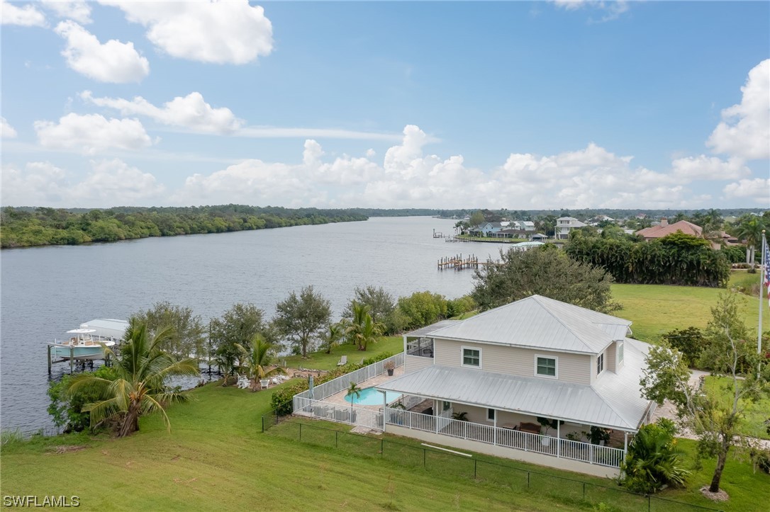 12614 River Road Fort Myers, FL 33905 - Photo 7 of 50 an aerial view of a house with a garden and lake view