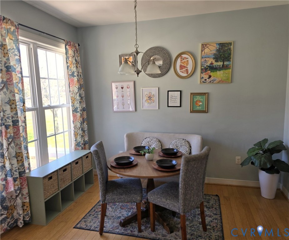68 Fitzhugh Street White Stone, VA 22578 - Photo 15 of 26 a view of a dining area with furniture window and wooden floor