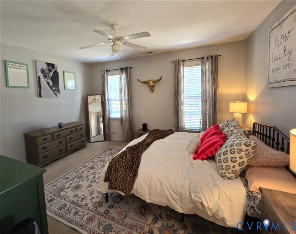 68 Fitzhugh Street White Stone, VA 22578 - Photo 19 of 26 a bedroom with a large bed and a chandelier