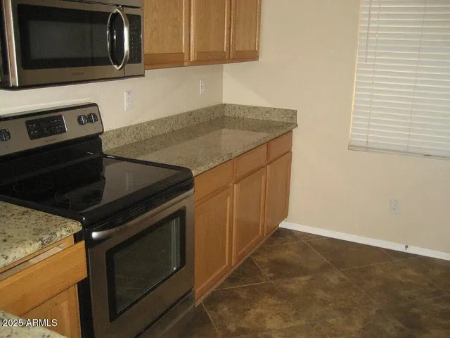 a kitchen with a stove microwave and sink