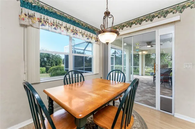a view of a dining room with furniture wooden floor and chandelier