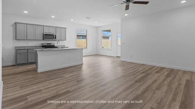 a view of kitchen with sink microwave and stove