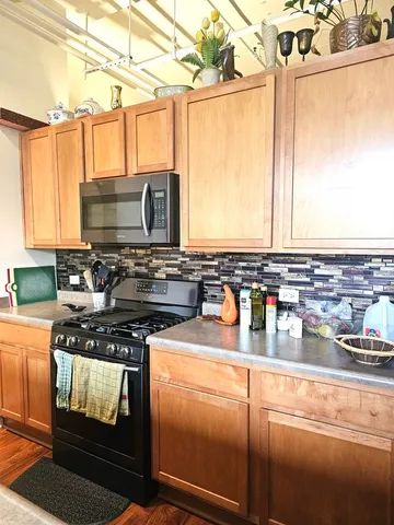a kitchen with stainless steel appliances granite countertop a stove and a microwave
