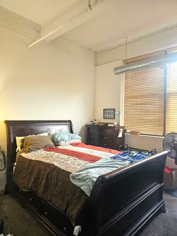a bedroom with a bed and window