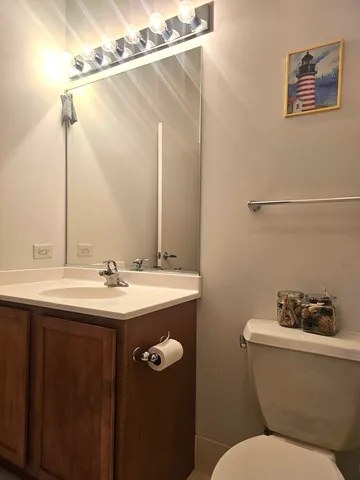 a bathroom with a sink and mirror with toilet