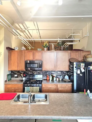 a kitchen with lots of appliances and cabinets