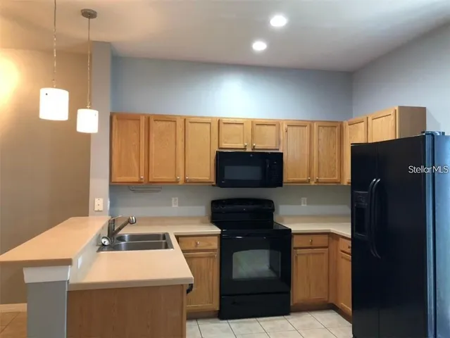 a kitchen with a refrigerator and a stove