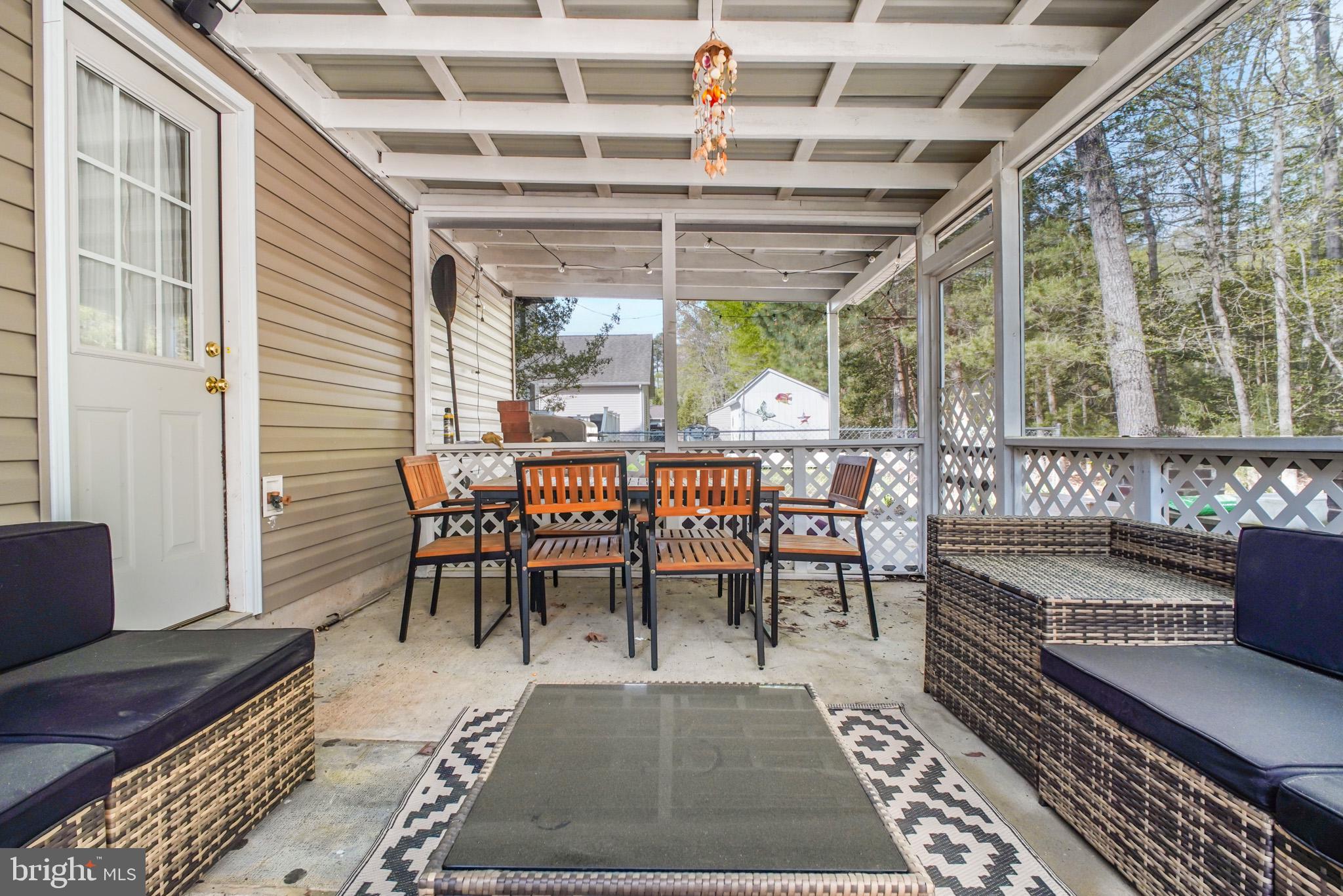 213 12th Street Colonial Beach, VA 22443 - Photo 17 of 31 Charming screened porch for relaxation.