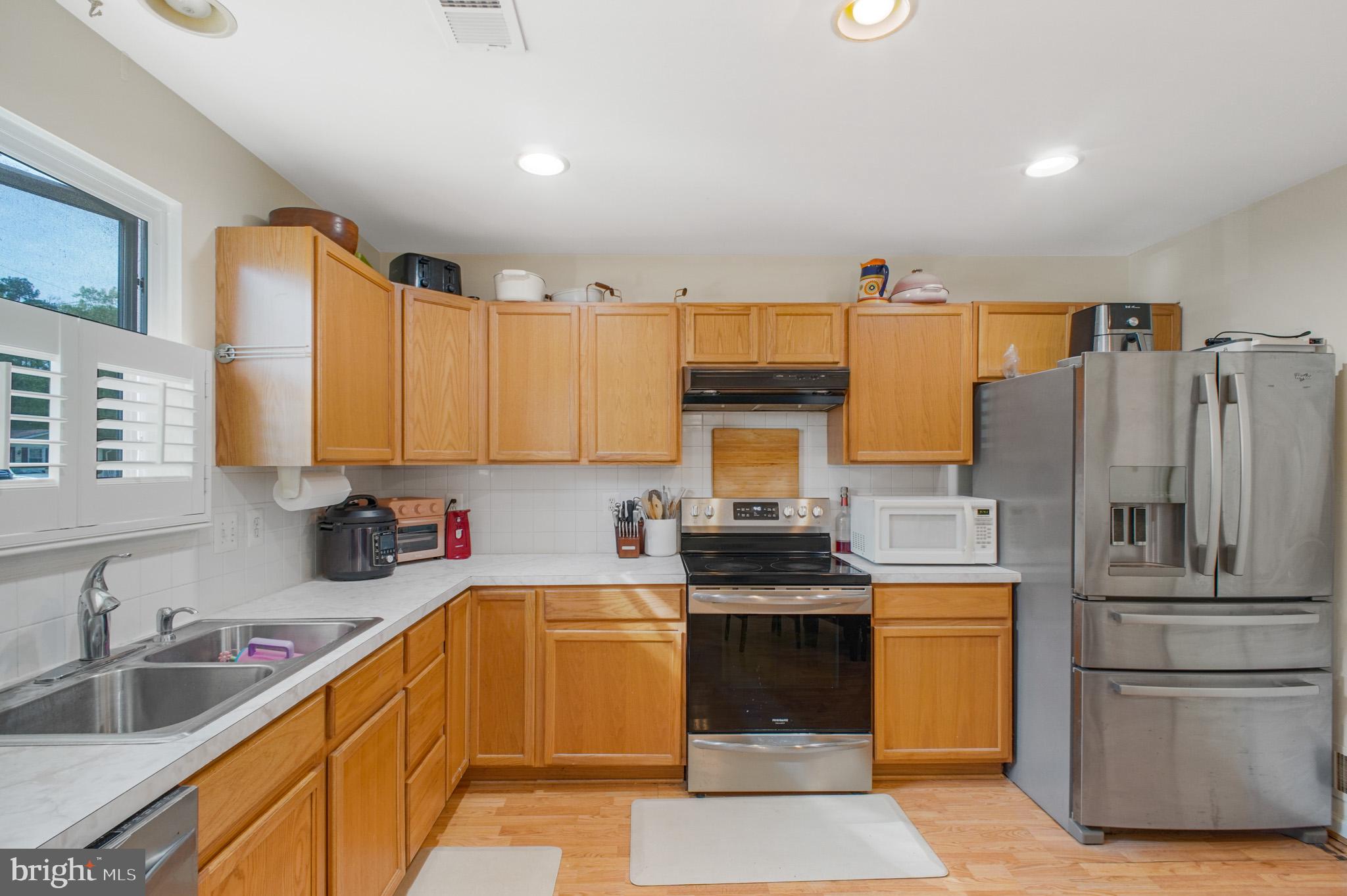 213 12th Street Colonial Beach, VA 22443 - Photo 9 of 31 Modern kitchen with warm wood tones.