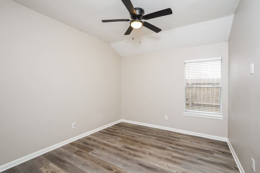 8911 Cypress Square Drive Spring, TX 77379 - Photo 13 of 16 an empty room with a window and a fan