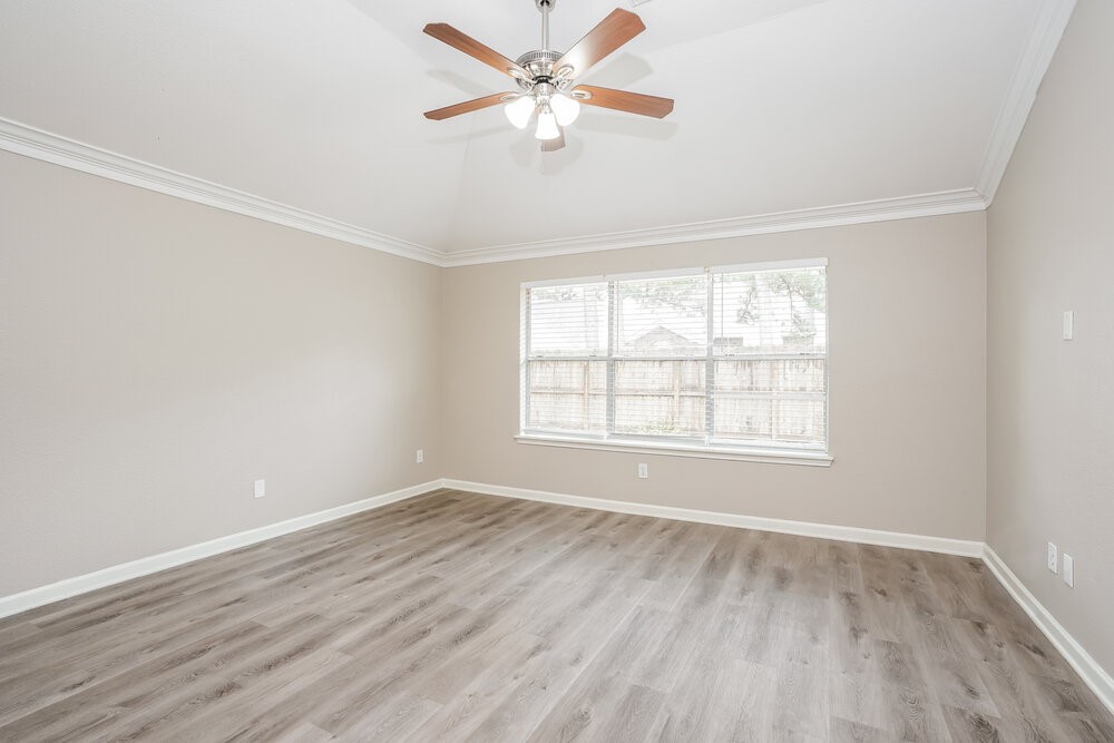 8911 Cypress Square Drive Spring, TX 77379 - Photo 9 of 16 wooden floor in an empty room with a window