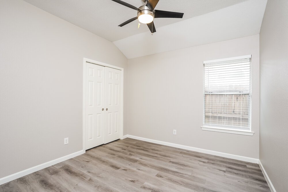 8911 Cypress Square Drive Spring, TX 77379 - Photo 10 of 16 a view of an empty room with wooden floor and a window
