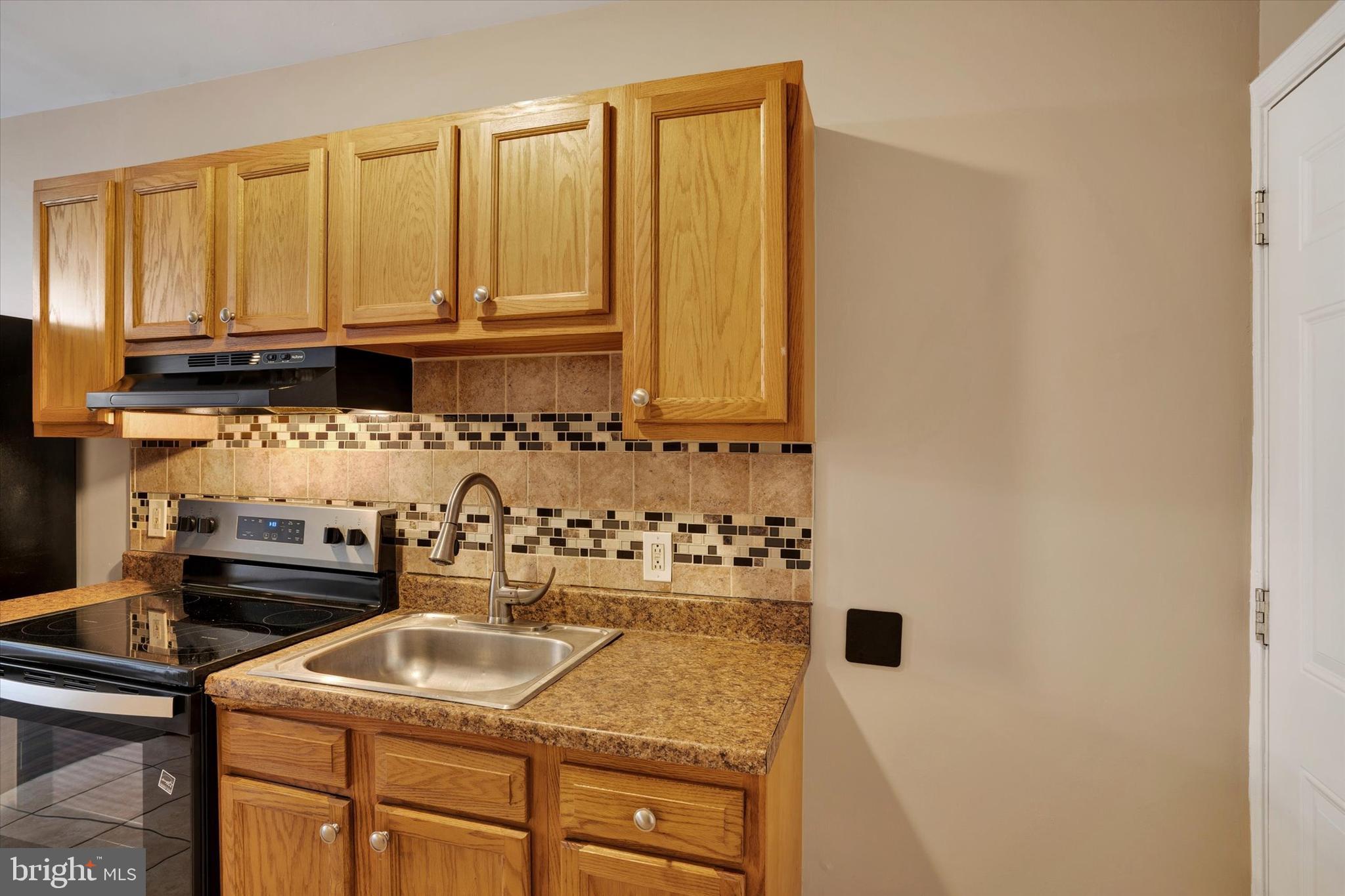 2010 East Boston Street Philadelphia, PA 19125 - Photo 8 of 25 a kitchen with granite countertop a sink a stove and cabinets