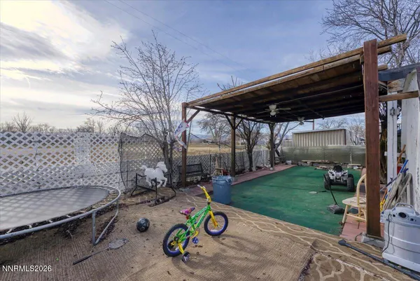 a view of backyard with wheel chair potted plants and large tree
