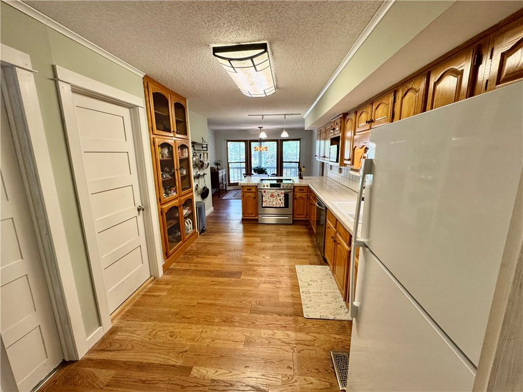 1012 King Mill Road McDonough, GA 30252 - Photo 12 of 64 a hallway with a large refrigerator a washer and dryer