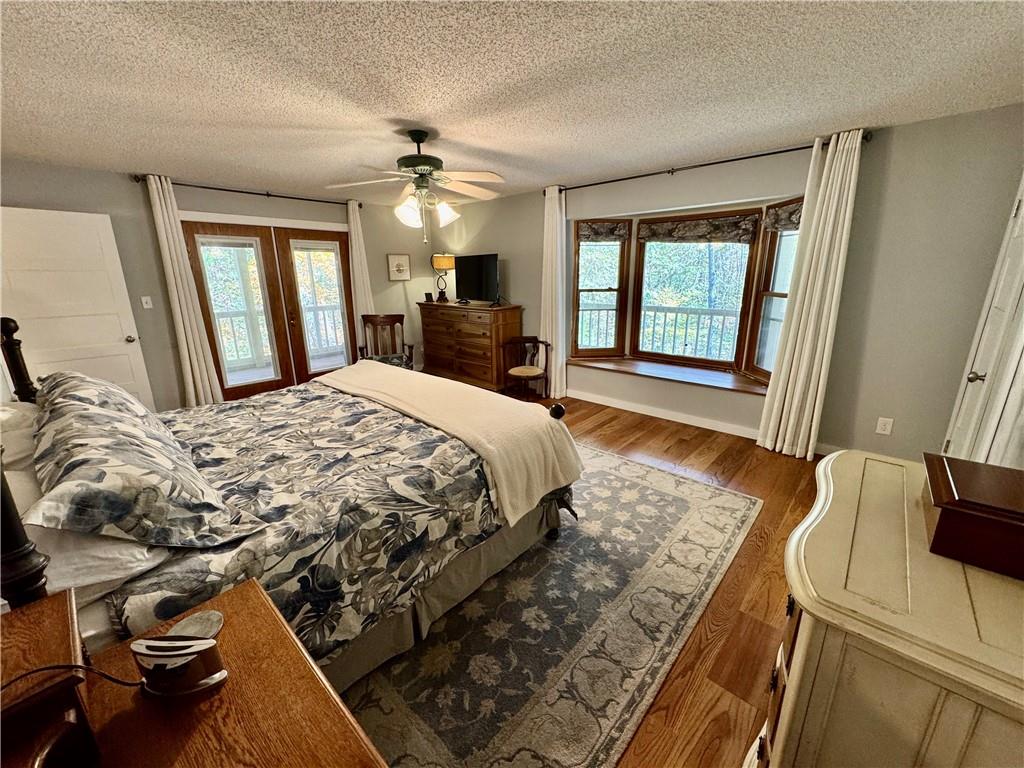 1012 King Mill Road McDonough, GA 30252 - Photo 19 of 64 a bedroom with a bed and wooden floor