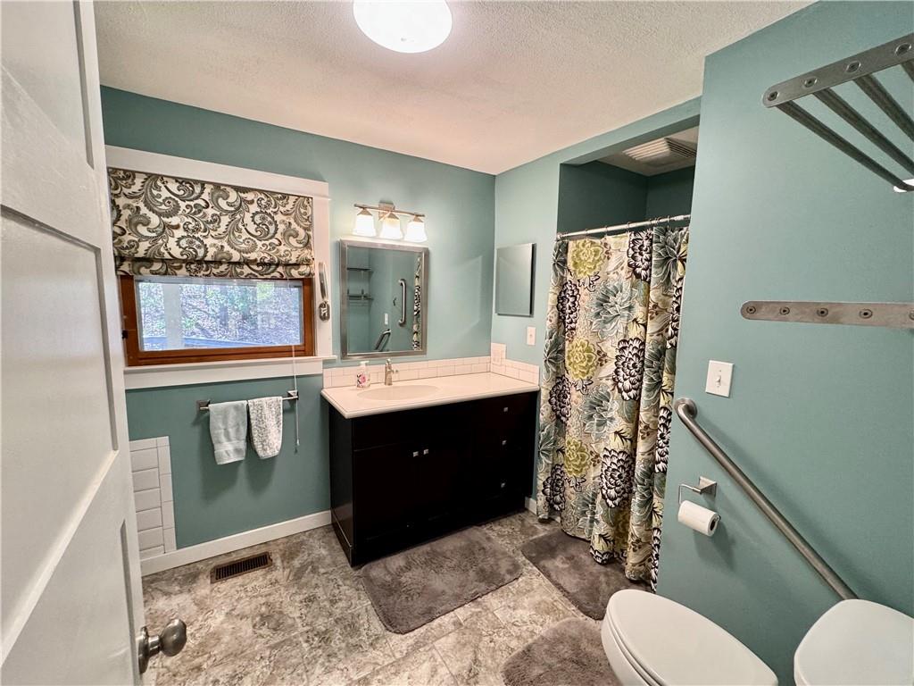 1012 King Mill Road McDonough, GA 30252 - Photo 21 of 64 a bathroom with a sink a toilet and shower