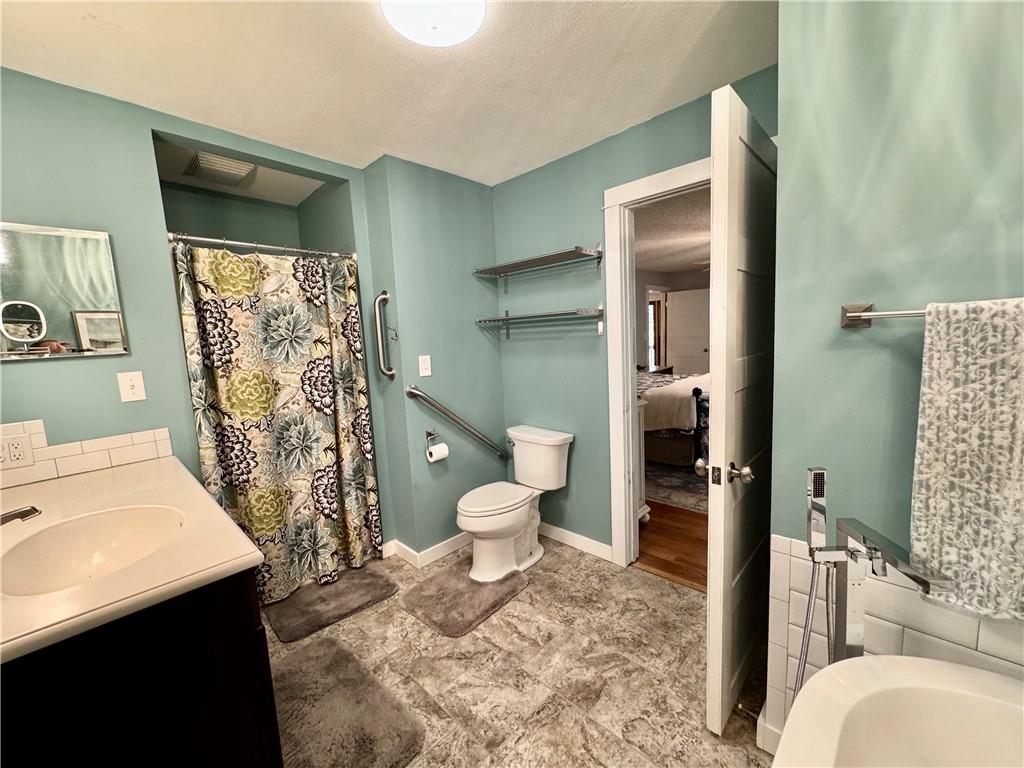 1012 King Mill Road McDonough, GA 30252 - Photo 23 of 64 a bathroom with a sink toilet and shower