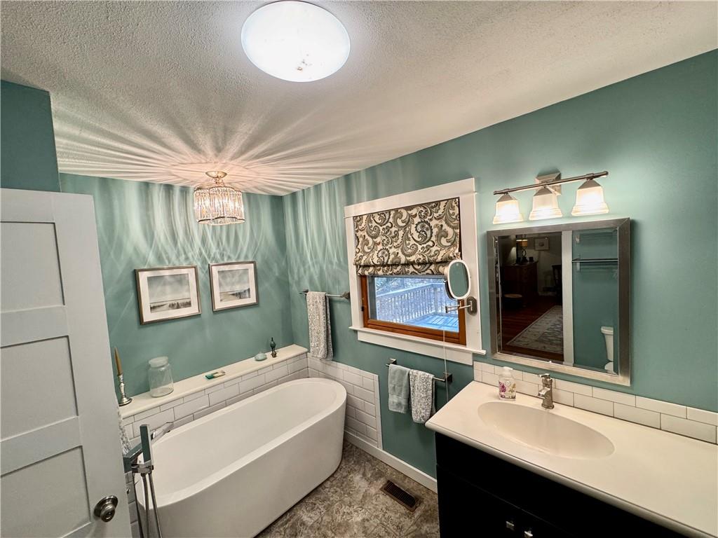 1012 King Mill Road McDonough, GA 30252 - Photo 24 of 64 a bathroom with a sink a large mirror and a bathtub