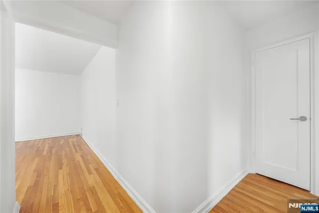 a view of a room with wooden floor and small space
