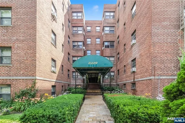 a front view of a building with garden