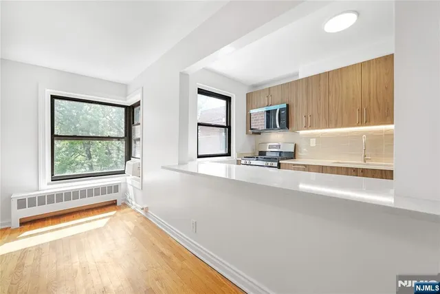 a view of a kitchen with a sink and a window