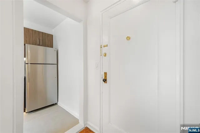 a view of a kitchen with a refrigerator