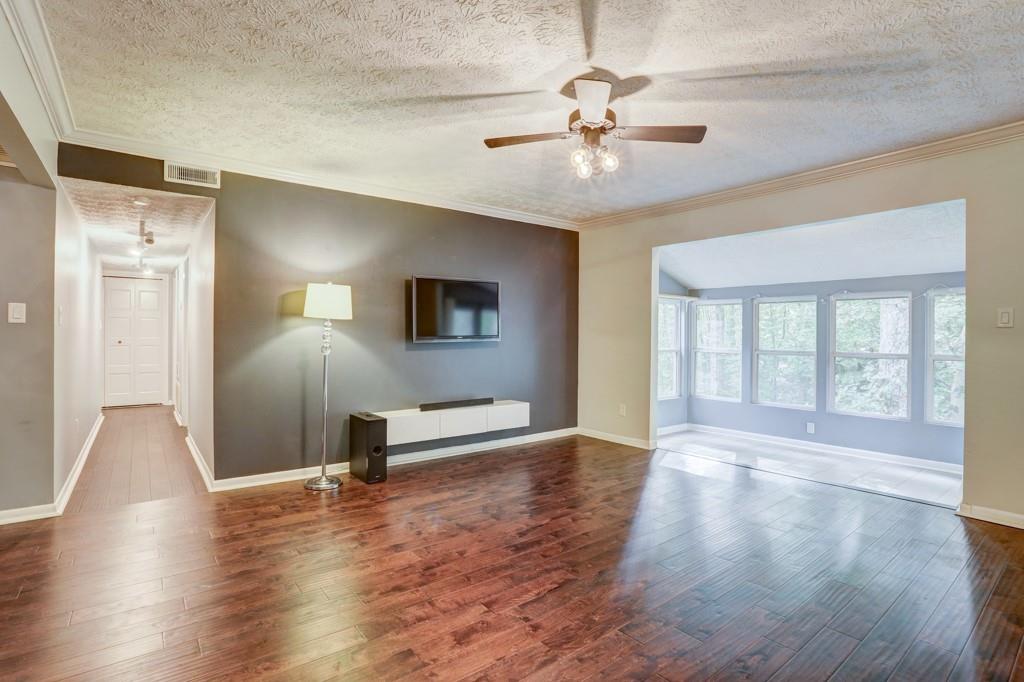 5149 Roswell Road, Unit 8 Atlanta, GA 30342 - Photo 1 of 1 Living Room, Sunroom, and hallway to bedrooms & bathroom, viewed from Foyer.