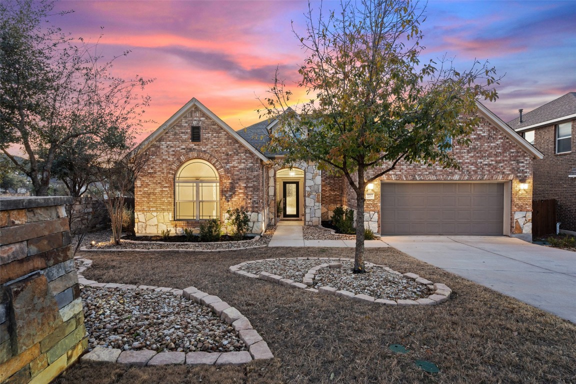 5712 Cherokee Draw Road Austin, TX 78738 - Photo 1 of 1 a front view of a house with garden