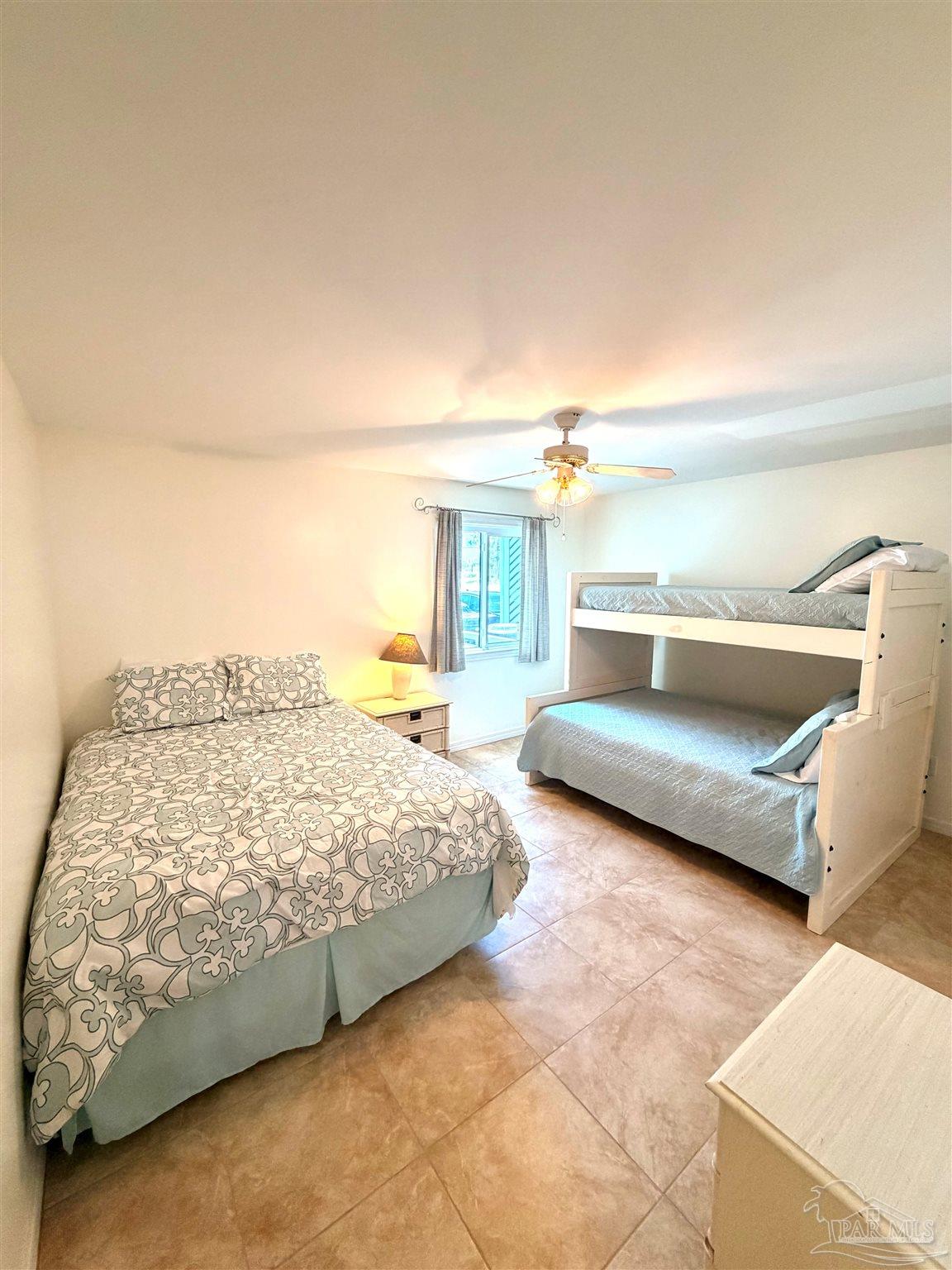 16470 Perdido Key Drive, Unit B13 Perdido Key, FL 32507 - Photo 16 of 17 a bedroom with a bed and a night stand