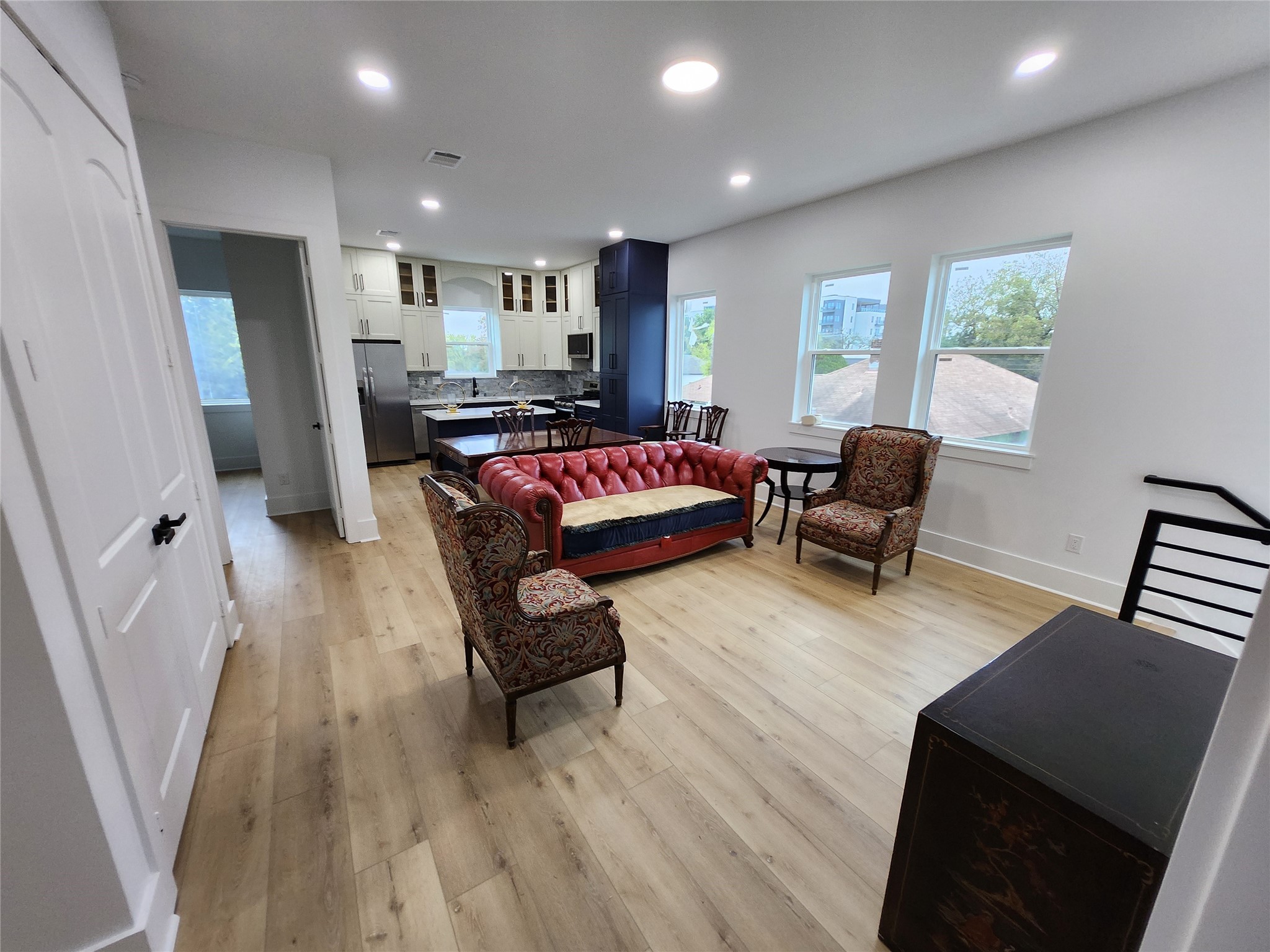 207 Carl Street Houston, TX 77009 - Photo 1 of 14 a living room with furniture and a wooden floor