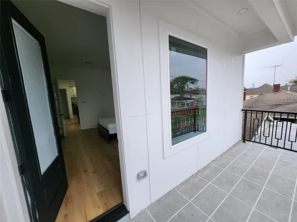 a view of balcony with car parked