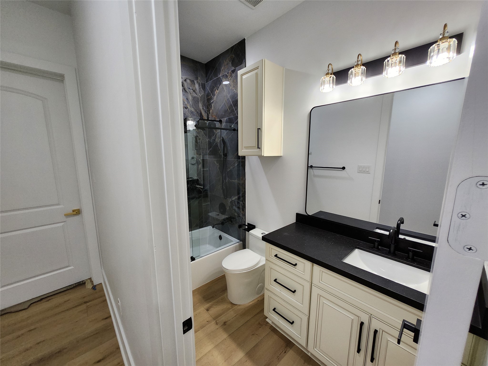 207 Carl Street Houston, TX 77009 - Photo 8 of 14 a bathroom with a granite countertop sink toilet and shower