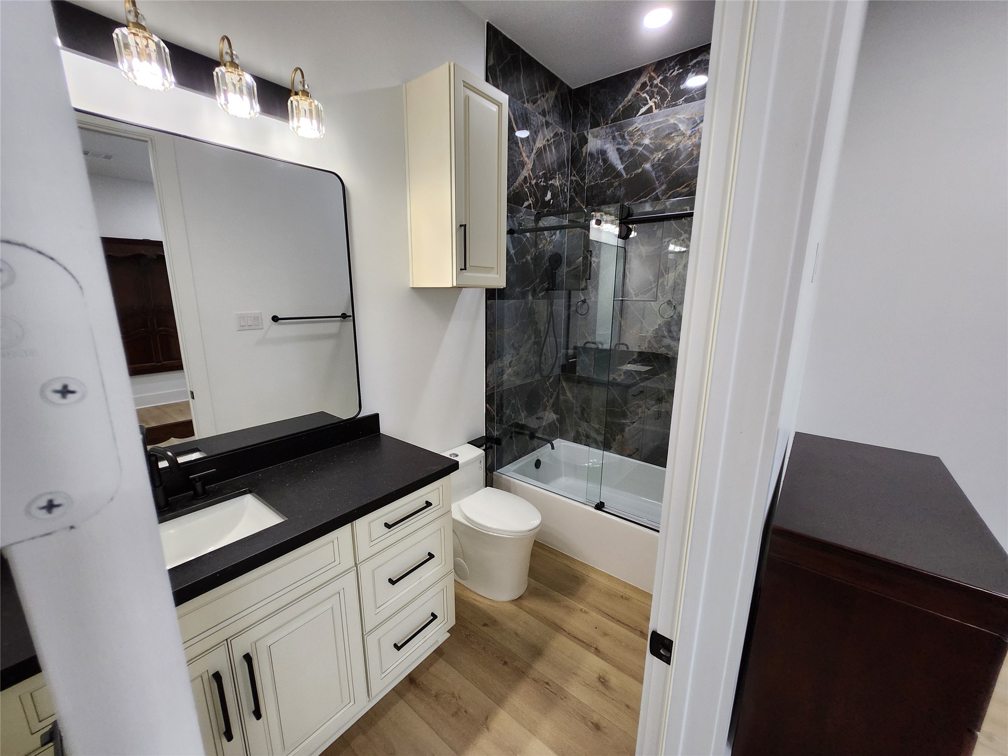 207 Carl Street Houston, TX 77009 - Photo 9 of 14 a bathroom with a granite countertop sink toilet and shower