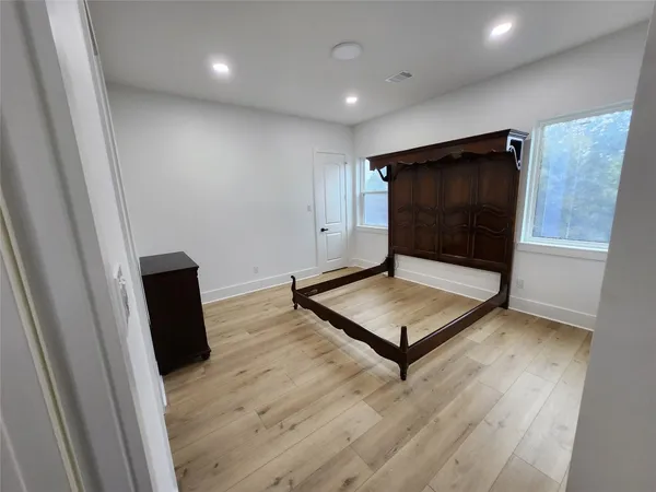 a living room with hard wood floors and a wooden floor