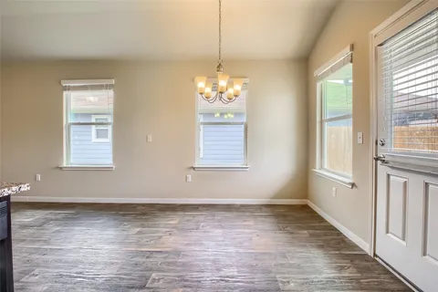 an empty room with chandelier fan