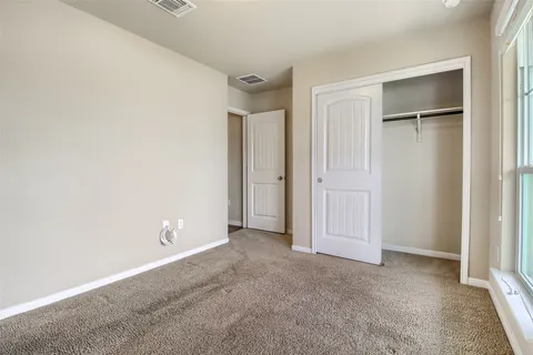 a view of a yard in front of a house with a garden