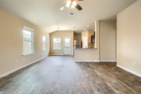 a kitchen with stainless steel appliances granite countertop a refrigerator a sink a stove with cabinets