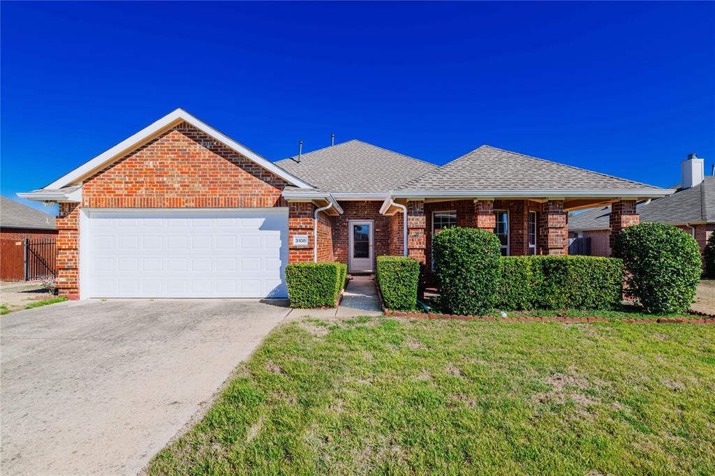 a front view of a house with yard and green space