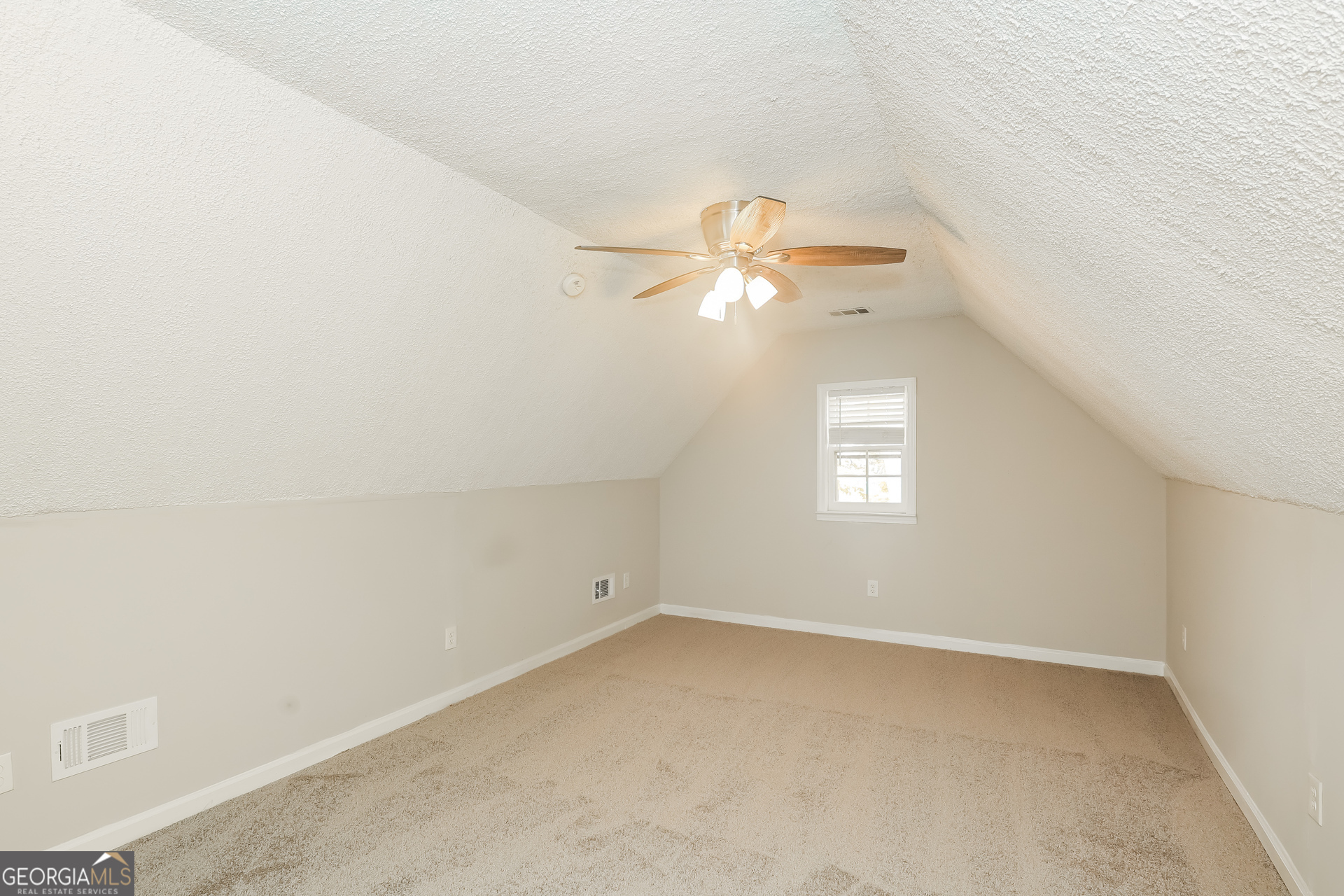 9183 Snipe Lane Jonesboro, GA 30236 - Photo 11 of 22 an empty room with a chandelier fan and a window