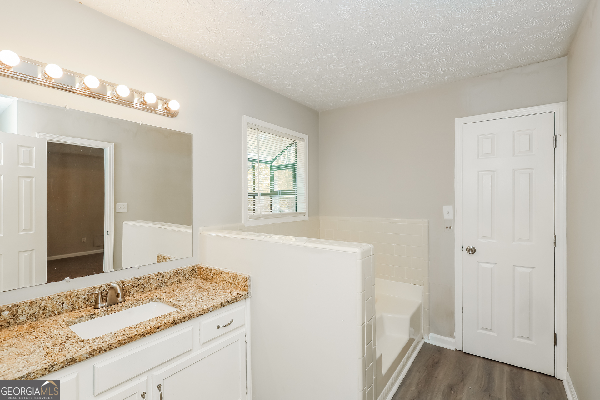 9183 Snipe Lane Jonesboro, GA 30236 - Photo 14 of 22 a bathroom with a granite countertop sink and a mirror
