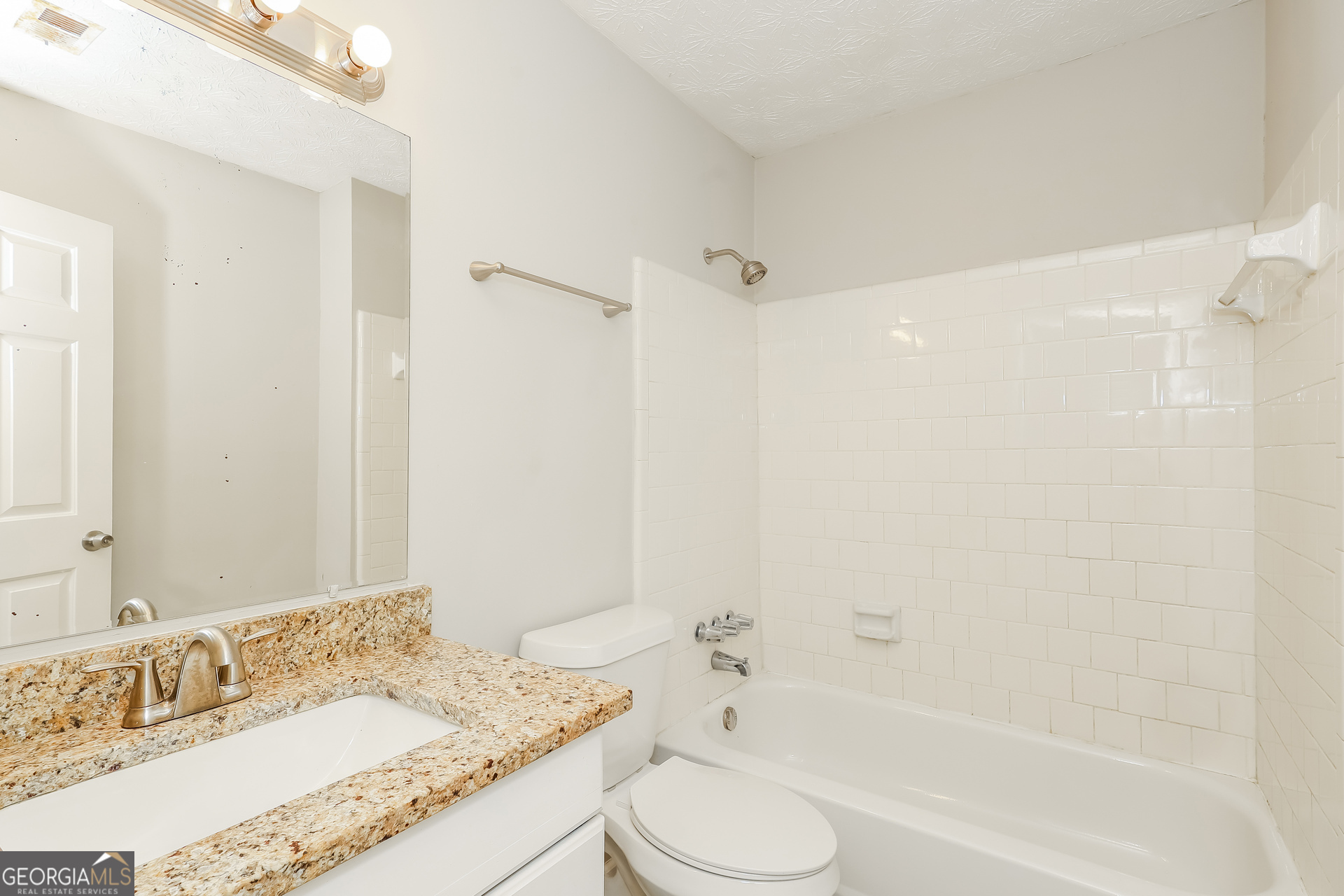 9183 Snipe Lane Jonesboro, GA 30236 - Photo 20 of 22 a bathroom with a granite countertop sink toilet and shower