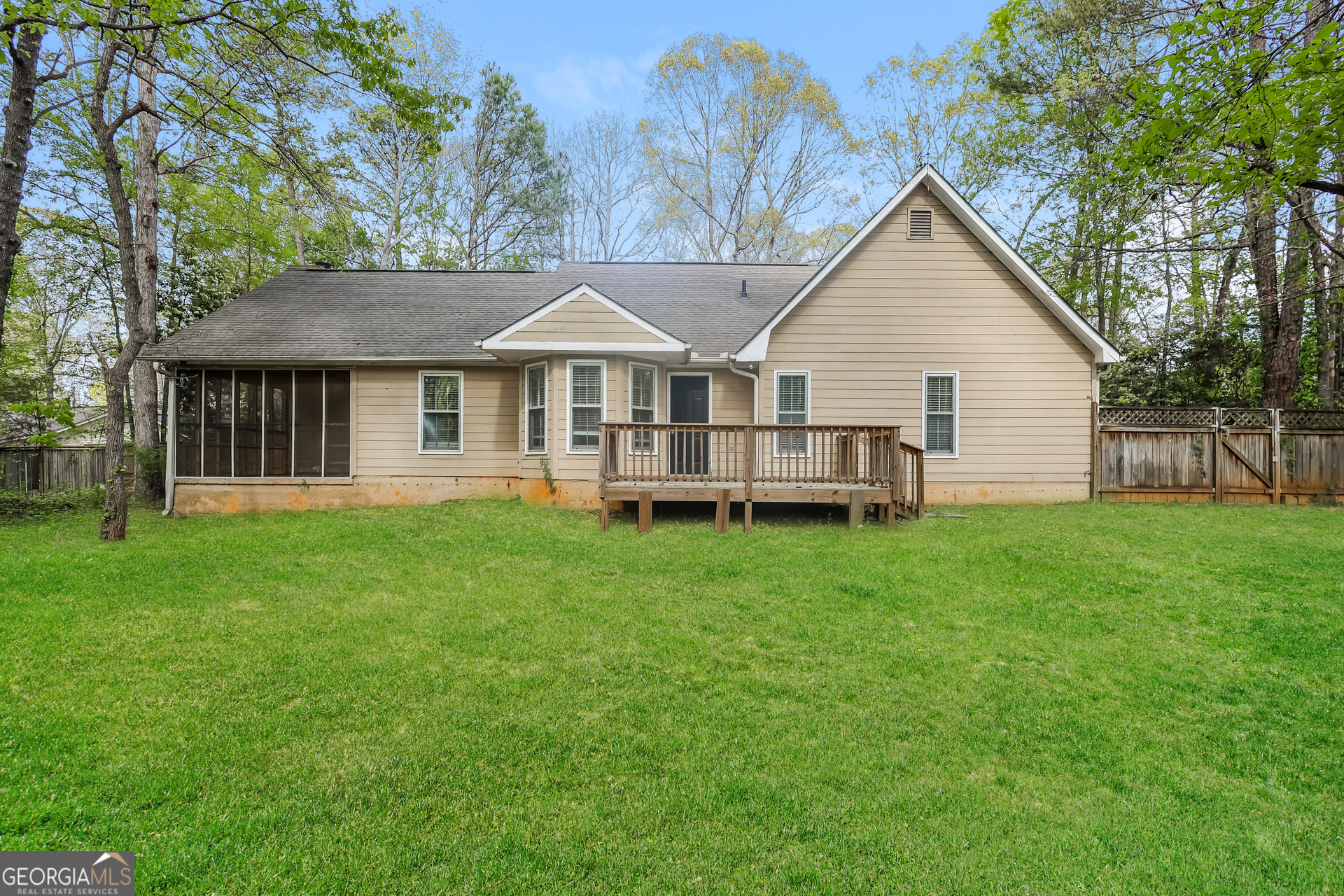 9183 Snipe Lane Jonesboro, GA 30236 - Photo 22 of 22 a view of a house with a yard and lawn chairs