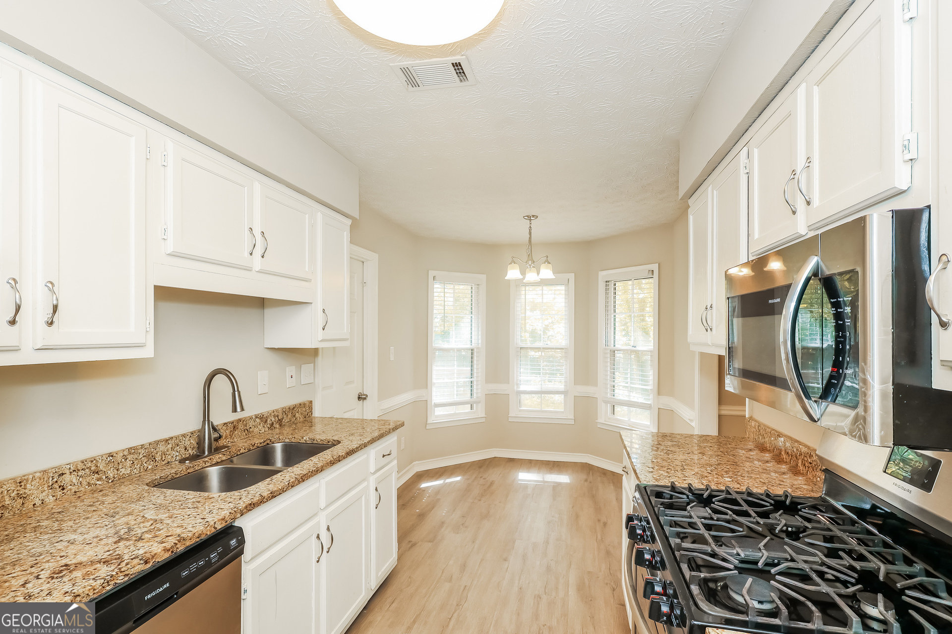 9183 Snipe Lane Jonesboro, GA 30236 - Photo 8 of 22 a kitchen with granite countertop a sink and a stove top oven