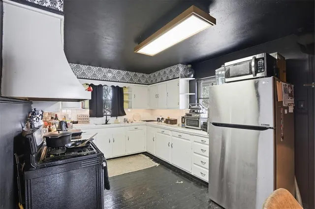 a kitchen with a sink and cabinets