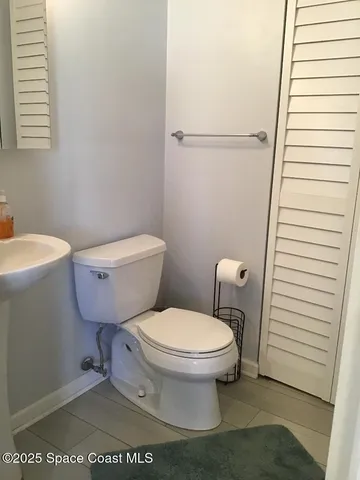 a white toilet sitting next to a white sink