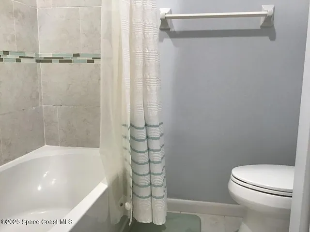 a bathroom with a shower and a toilet