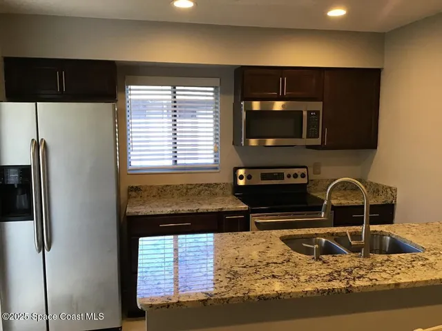 a kitchen with a stove a sink and a microwave