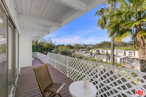 a view of balcony with furniture