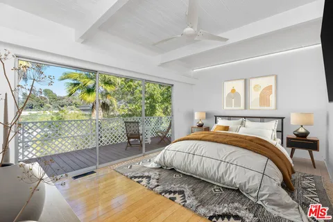 a bedroom with a bed and a large window